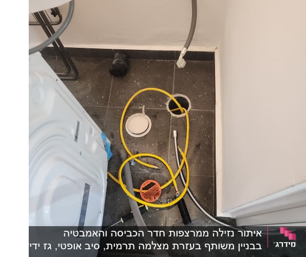 צינור צהוב וכלי עבודה על רצפת חדר אמבטיה